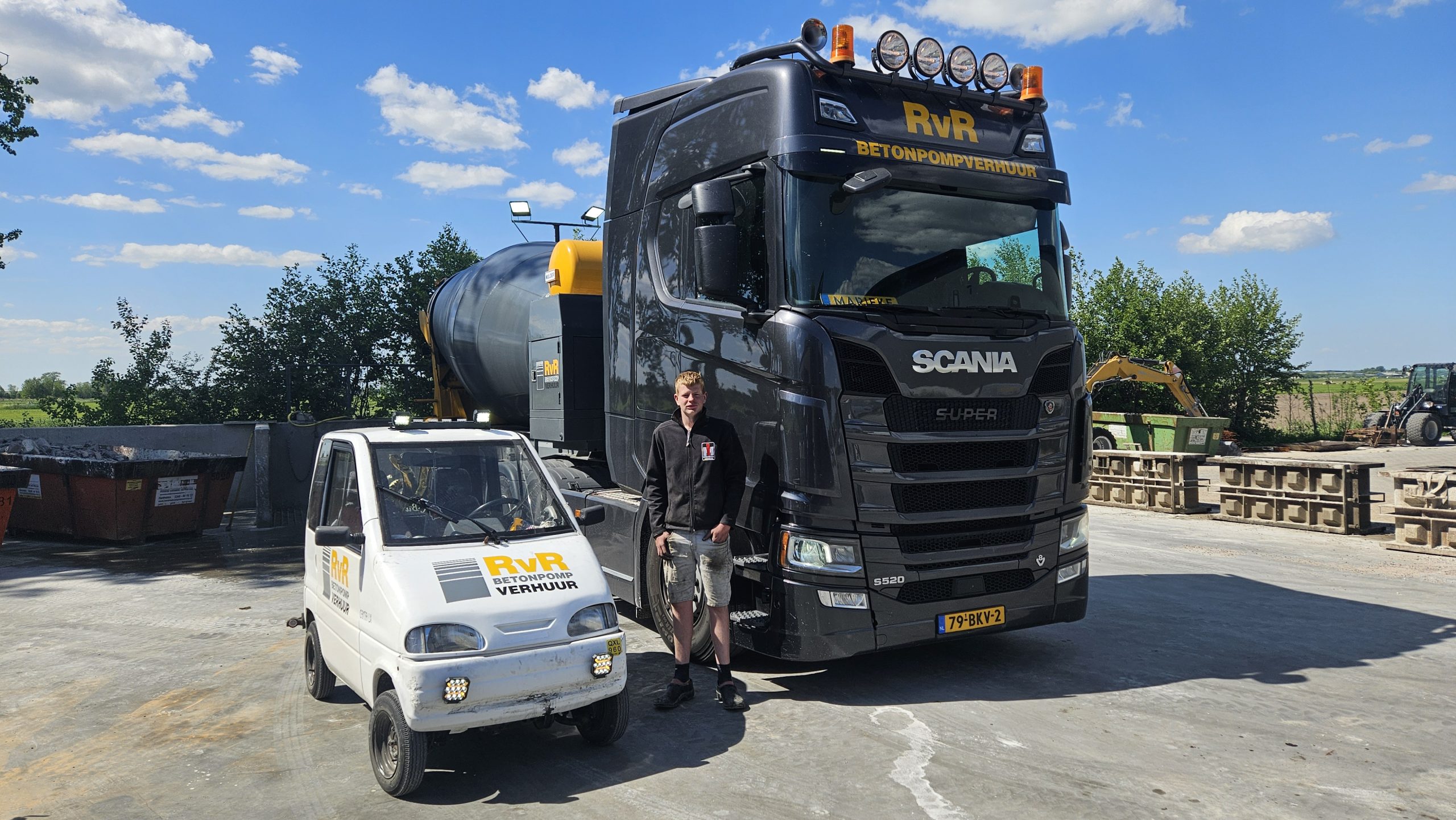 Jonge stagiair Nic met zijn Canta naast een betonmixer van RvR Betonpomp Verhuur